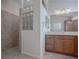 Bathroom with walk-in shower and glass block feature at 3144 Blackstock Way, The Villages, FL 32163