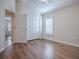 Bedroom with wood floors, closet, and window shutters at 3144 Blackstock Way, The Villages, FL 32163