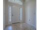 Bright entryway with tiled floors and a white front door at 3144 Blackstock Way, The Villages, FL 32163