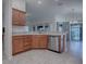 Kitchen island with sink, dishwasher, and ample counter space at 3144 Blackstock Way, The Villages, FL 32163