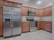 Kitchen with stainless steel appliances and wood cabinets at 3144 Blackstock Way, The Villages, FL 32163