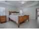 Spacious main bedroom with a wooden bed frame and nightstands at 3144 Blackstock Way, The Villages, FL 32163