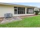 Backyard patio with grill and screened enclosure at 353 Ranchwood Dr, Leesburg, FL 34748