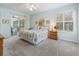 Bright bedroom with king bed, sliding doors to patio, and ceiling fan at 353 Ranchwood Dr, Leesburg, FL 34748