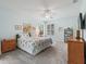 Main bedroom with a king-size bed, neutral carpeting and a ceiling fan at 353 Ranchwood Dr, Leesburg, FL 34748