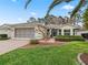 Single-story home with screened porch and landscaped yard at 353 Ranchwood Dr, Leesburg, FL 34748