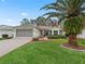 House exterior with palm tree and brick paver driveway at 353 Ranchwood Dr, Leesburg, FL 34748