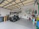 Garage with golf cart and storage shelving at 353 Ranchwood Dr, Leesburg, FL 34748