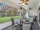 Sunroom with table and chairs, overlooking the yard at 353 Ranchwood Dr, Leesburg, FL 34748