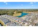 Aerial view showing house location in community near a pond at 3575 Grouby Rd, The Villages, FL 32163