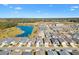 Aerial view showing house location in community near a pond at 3575 Grouby Rd, The Villages, FL 32163