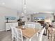 Bright dining room with a wood table, white chairs, and hardwood floors at 3575 Grouby Rd, The Villages, FL 32163