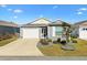 Gray vinyl-sided home with a two-car garage and landscaped front yard at 3575 Grouby Rd, The Villages, FL 32163