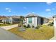 Exterior view of a charming house with a landscaped yard at 3575 Grouby Rd, The Villages, FL 32163