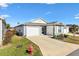 Gray house with a two-car garage and driveway, plus a fire hydrant at 3575 Grouby Rd, The Villages, FL 32163