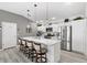 Modern kitchen with white cabinets, stainless steel appliances, and an island at 3575 Grouby Rd, The Villages, FL 32163