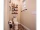 Charming bathroom with rustic shelves and updated toilet at 41516 Saddle Ridge Ln, Weirsdale, FL 32195