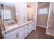 Double vanity bathroom with granite countertops and custom cabinetry at 41516 Saddle Ridge Ln, Weirsdale, FL 32195