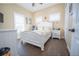 Charming bedroom with a white bed frame and wood floors at 41516 Saddle Ridge Ln, Weirsdale, FL 32195