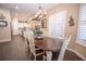 Farmhouse style dining room with wood table and white chairs at 41516 Saddle Ridge Ln, Weirsdale, FL 32195