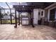 Outdoor kitchen with built-in grill under a covered pergola at 41516 Saddle Ridge Ln, Weirsdale, FL 32195