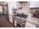 Stainless steel gas range and granite countertops in the kitchen at 41516 Saddle Ridge Ln, Weirsdale, FL 32195