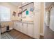 Laundry room features white cabinets, granite countertops, and a convenient utility sink at 41516 Saddle Ridge Ln, Weirsdale, FL 32195