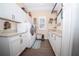 Bright laundry room with ample cabinetry, granite countertops, and high-end washer and dryer at 41516 Saddle Ridge Ln, Weirsdale, FL 32195