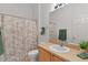 Well-lit bathroom featuring a neutral color scheme and a patterned shower curtain at 424 Rose Croft Ter, The Villages, FL 32162