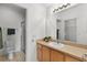 Bathroom with a vanity, a large mirror, and a walk-in shower at 424 Rose Croft Ter, The Villages, FL 32162