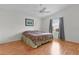 Comfortable bedroom with wood floors and a ceiling fan for added comfort at 424 Rose Croft Ter, The Villages, FL 32162