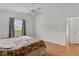 Bedroom with wood floors, a window and view to the back yard at 424 Rose Croft Ter, The Villages, FL 32162