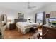 Main bedroom with wood flooring and wicker furniture at 424 Rose Croft Ter, The Villages, FL 32162