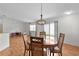 Dining room area with wood floors and a round table with four chairs at 424 Rose Croft Ter, The Villages, FL 32162