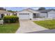 Front view of a house with a white picket fence and driveway at 424 Rose Croft Ter, The Villages, FL 32162