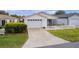 Charming single-story home exterior featuring a white picket fence and attached garage at 424 Rose Croft Ter, The Villages, FL 32162