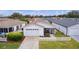 Front view of a house with a white picket fence and driveway at 424 Rose Croft Ter, The Villages, FL 32162