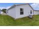 Exterior showcasing vinyl siding, well-maintained lawn, and an outdoor air conditioning unit at 424 Rose Croft Ter, The Villages, FL 32162