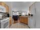 Clean kitchen with light wood cabinets and white appliances at 424 Rose Croft Ter, The Villages, FL 32162