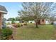 Backyard with shed, landscaping, and partially fenced at 438 Woodview Dr, Tavares, FL 32778