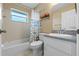 Bathroom with tub, toilet, vanity, and floral shower curtain at 438 Woodview Dr, Tavares, FL 32778