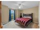 Bedroom with carpeted floor, ceiling fan, and striped bedding at 438 Woodview Dr, Tavares, FL 32778