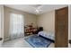 Bedroom with carpeted floor, ceiling fan, and built-in shelving at 438 Woodview Dr, Tavares, FL 32778