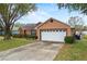 Attached garage with driveway and landscaping at 438 Woodview Dr, Tavares, FL 32778