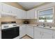 Efficient kitchen with white cabinets, microwave, and dishwasher at 438 Woodview Dr, Tavares, FL 32778