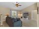 Living room with sectional sofa, electric fireplace, and vaulted ceiling at 438 Woodview Dr, Tavares, FL 32778