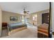 Main bedroom with carpeted floor, ceiling fan, and ensuite bathroom at 438 Woodview Dr, Tavares, FL 32778