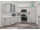 Bright kitchen featuring gray cabinets and herringbone backsplash at 4406 Creighton Loop, The Villages, FL 32163