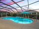 Stunning pool at sunset, complete with a screened enclosure and patio furniture at 4406 Creighton Loop, The Villages, FL 32163