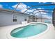 Inviting kidney-shaped pool with screened enclosure, perfect for relaxation at 4518 Hummingbird Ln, Haines City, FL 33844